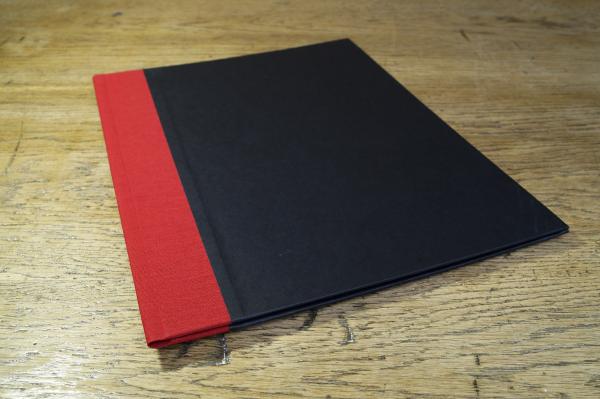 Black binder, red linen, elastic strap